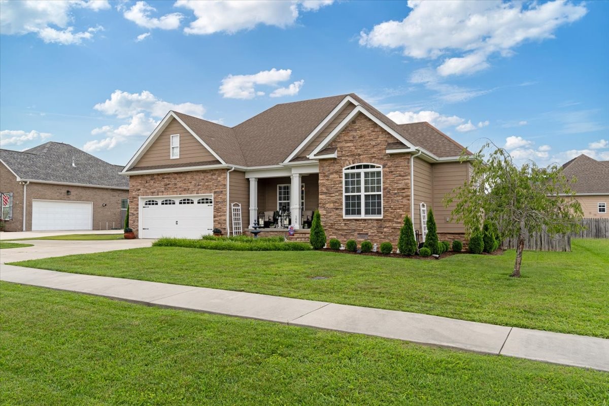 106 Riley Creek Road Tullahoma, TN 37388 - Photo 25 of 25 a front view of a house with a garden and trees