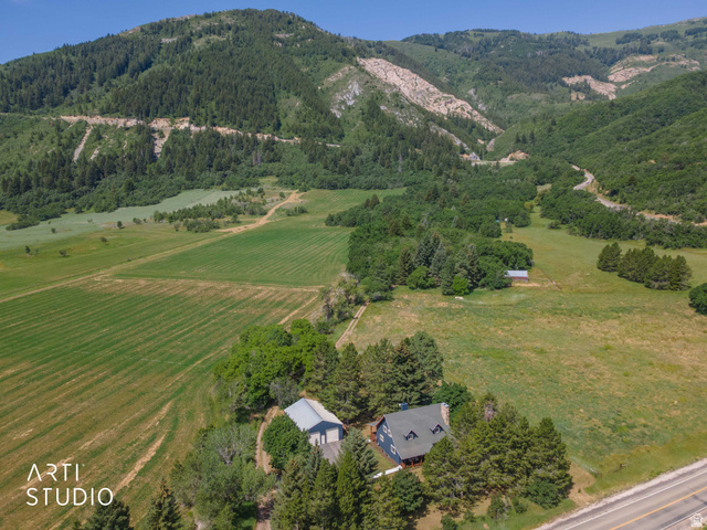 2807 North Ogden Canyon Road Eden, UT 84310 - Photo 56 of 72 Expansive rural property featuring a traditional-style dwelling, a separate outbuilding, mature evergreen trees, and surrounding green fields