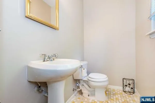 a bathroom with a sink toilet and a mirror