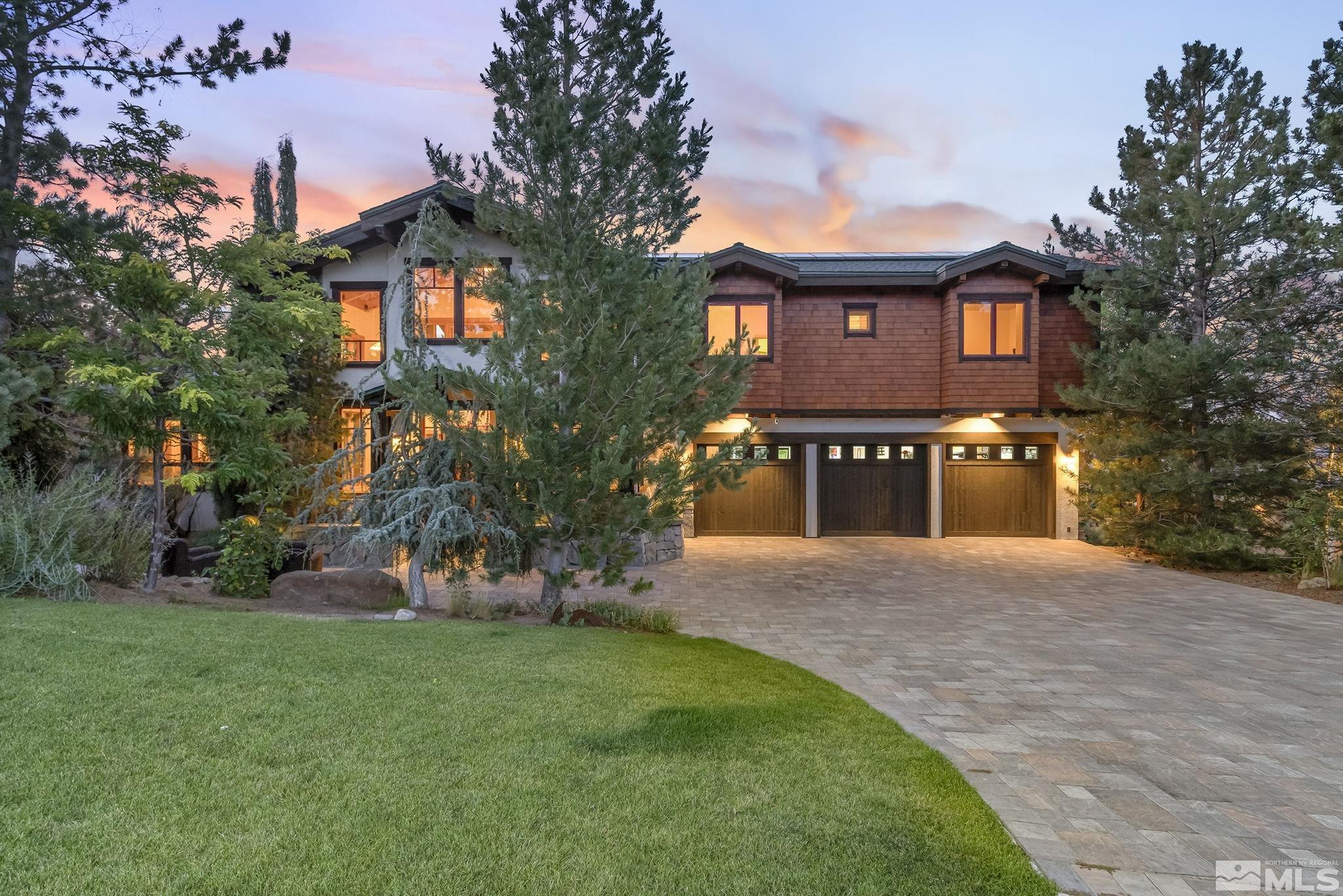 7035 Quail Rock Lane Reno, NV 89511 - Photo 1 of 37 a front view of a house with a yard and trees