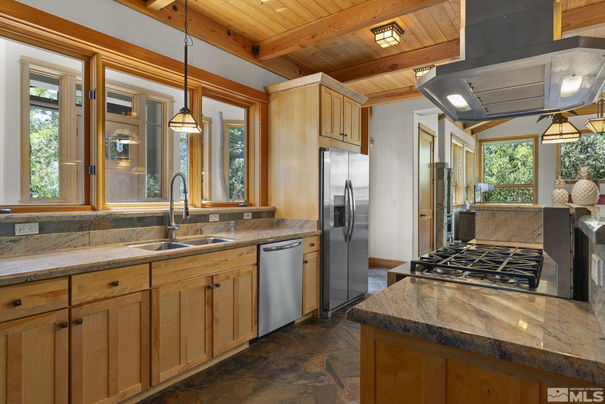 7035 Quail Rock Lane Reno, NV 89511 - Photo 14 of 37 a kitchen with a sink and refrigerator