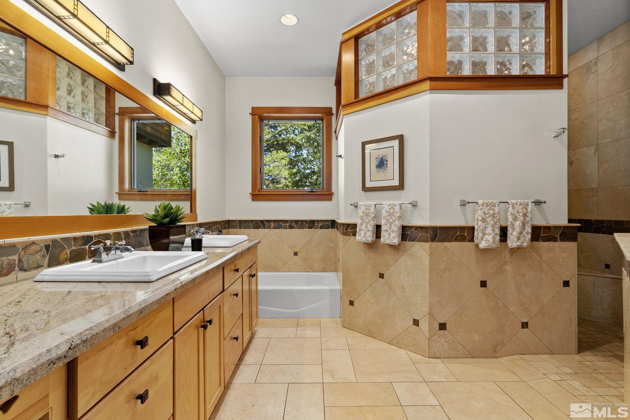 7035 Quail Rock Lane Reno, NV 89511 - Photo 17 of 37 a spacious bathroom with a tub sink and mirror