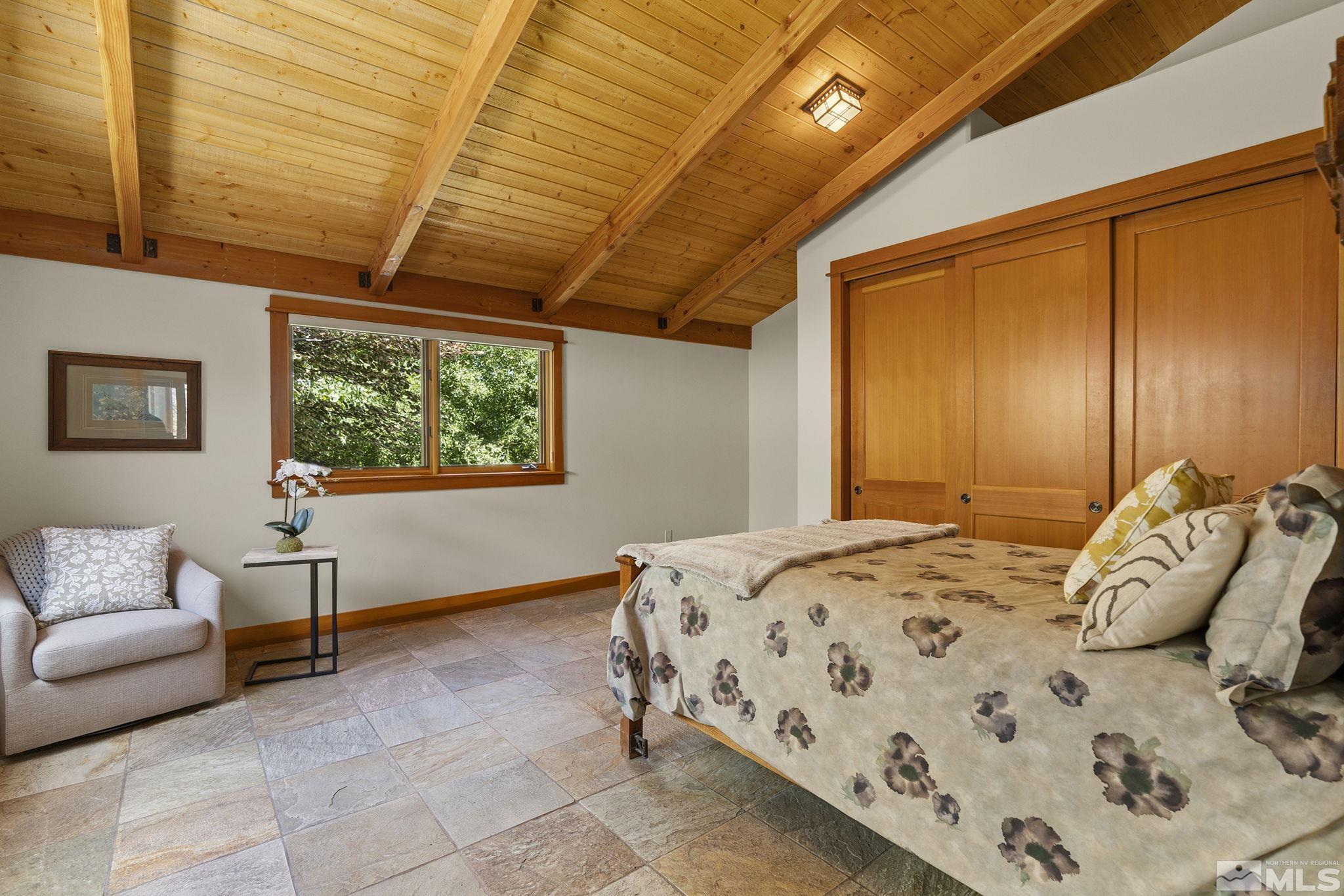 7035 Quail Rock Lane Reno, NV 89511 - Photo 18 of 37 a bedroom with a bed and a couch