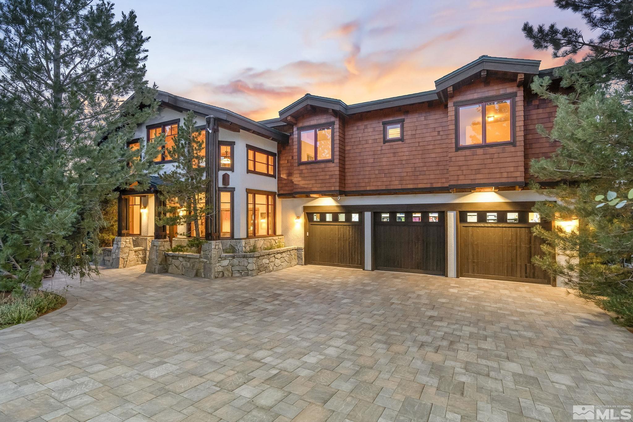 7035 Quail Rock Lane Reno, NV 89511 - Photo 2 of 37 a front view of a house with a yard and table and chairs