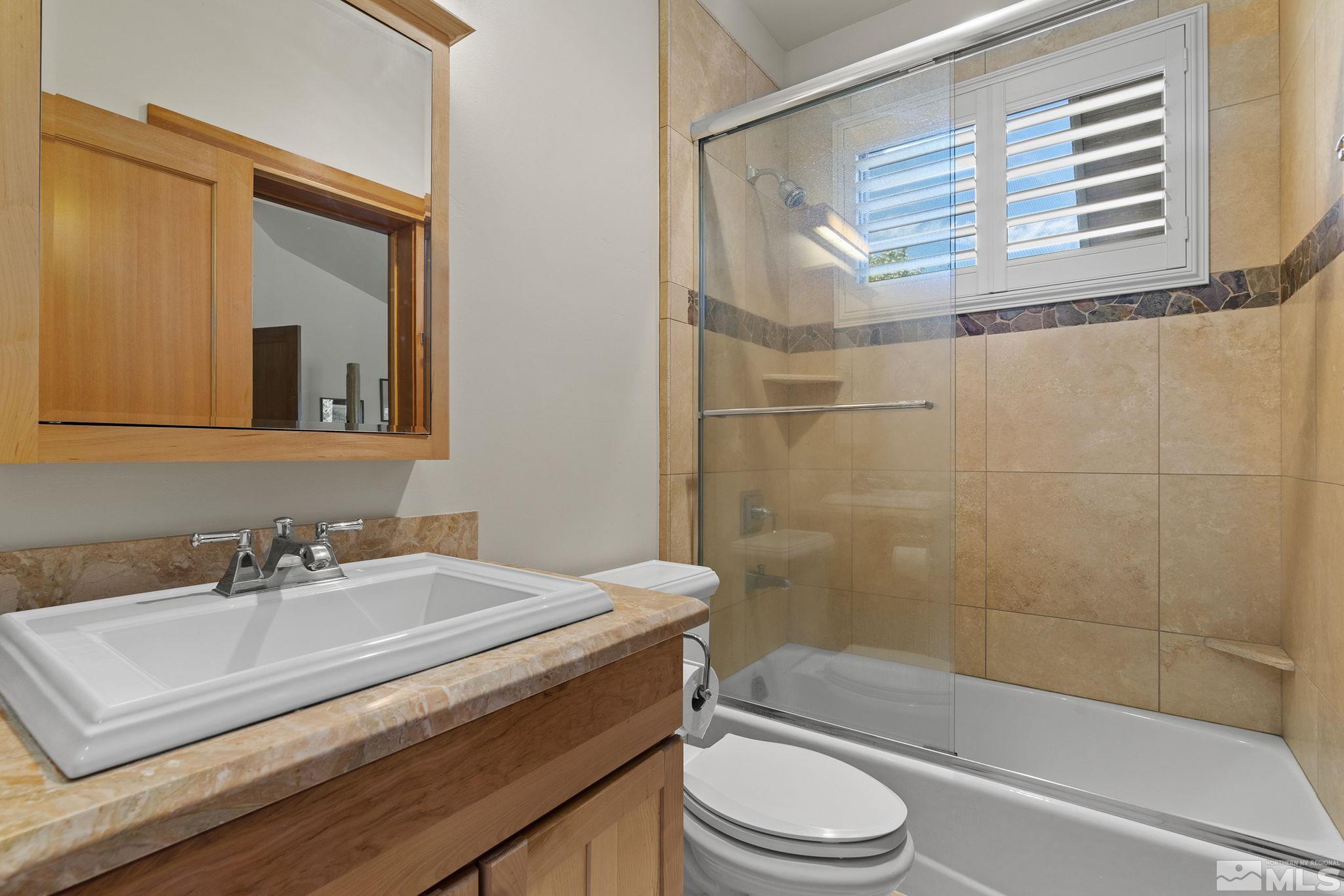 7035 Quail Rock Lane Reno, NV 89511 - Photo 21 of 37 a bathroom with a sink toilet and shower