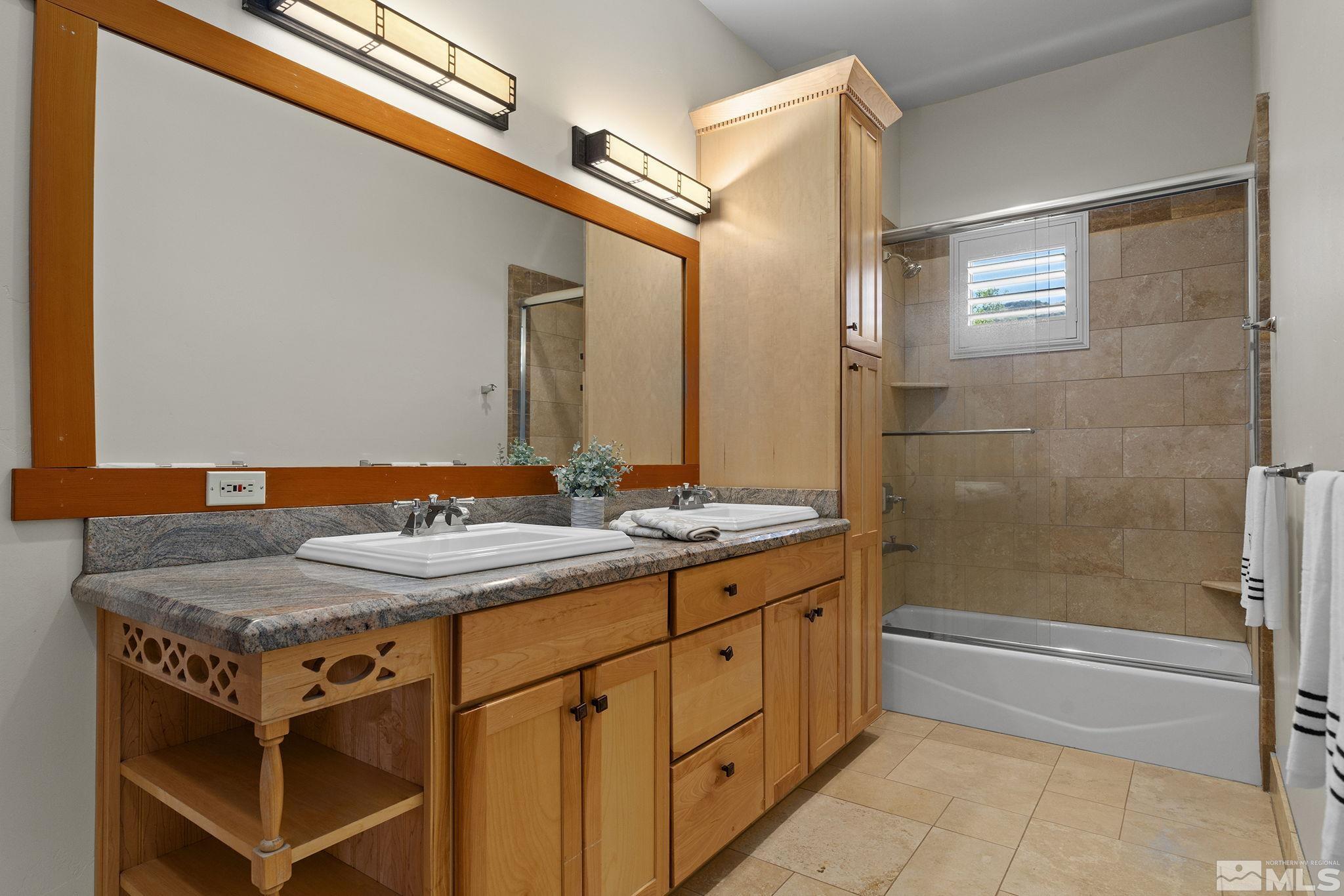 7035 Quail Rock Lane Reno, NV 89511 - Photo 23 of 37 a bathroom with a granite countertop sink and a mirror