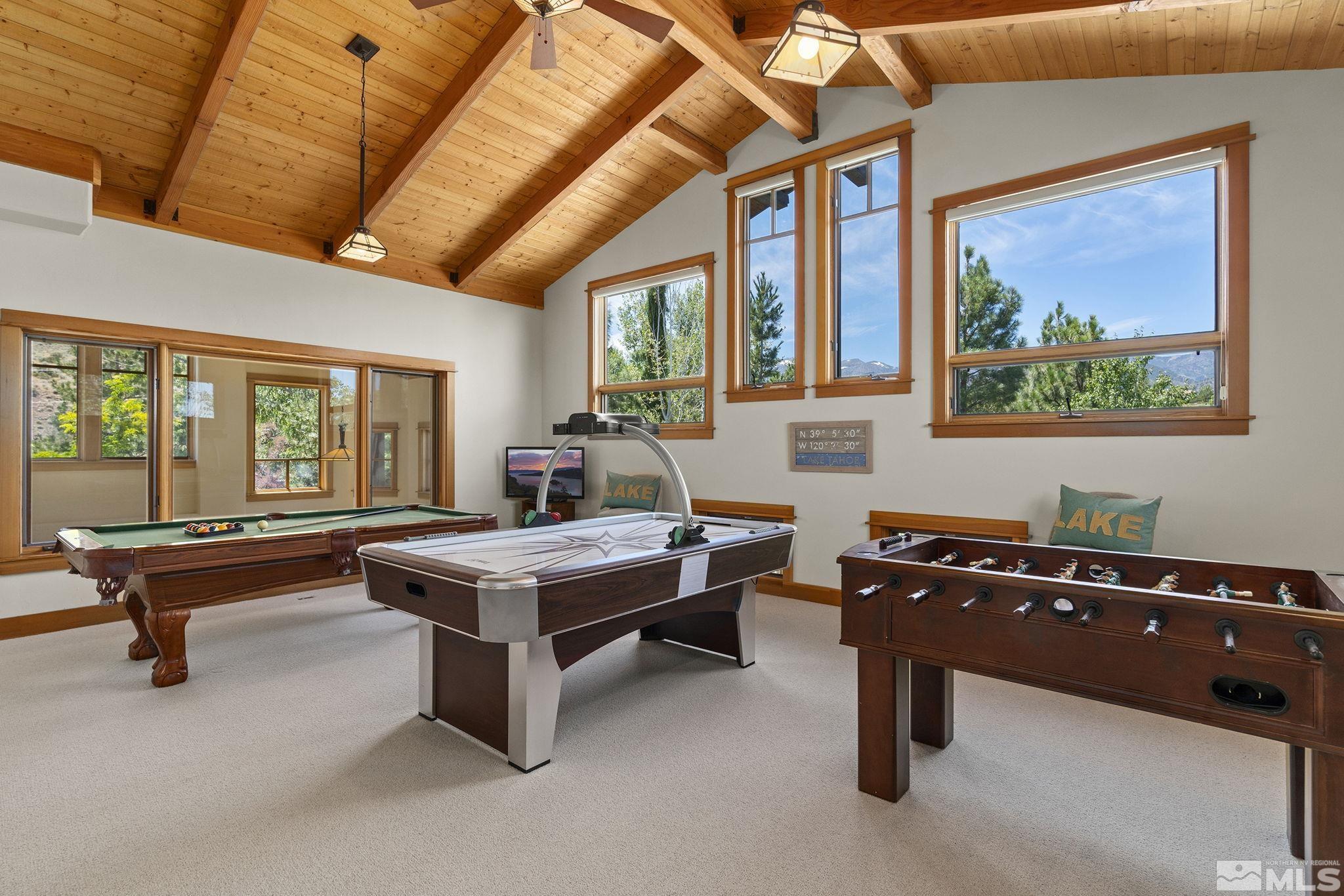 7035 Quail Rock Lane Reno, NV 89511 - Photo 27 of 37 a living room with furniture a table and a large window