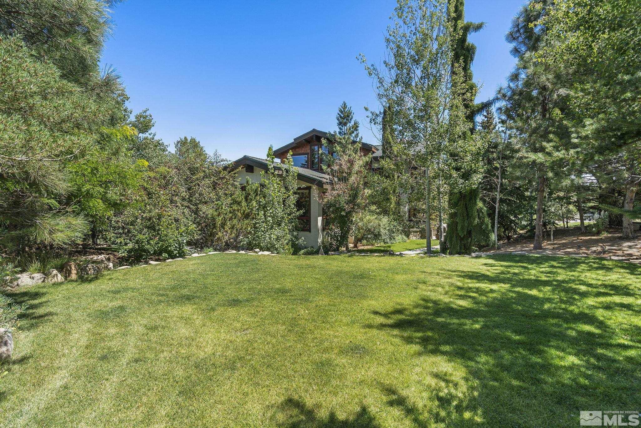 7035 Quail Rock Lane Reno, NV 89511 - Photo 33 of 37 a backyard of a house with lots of green space