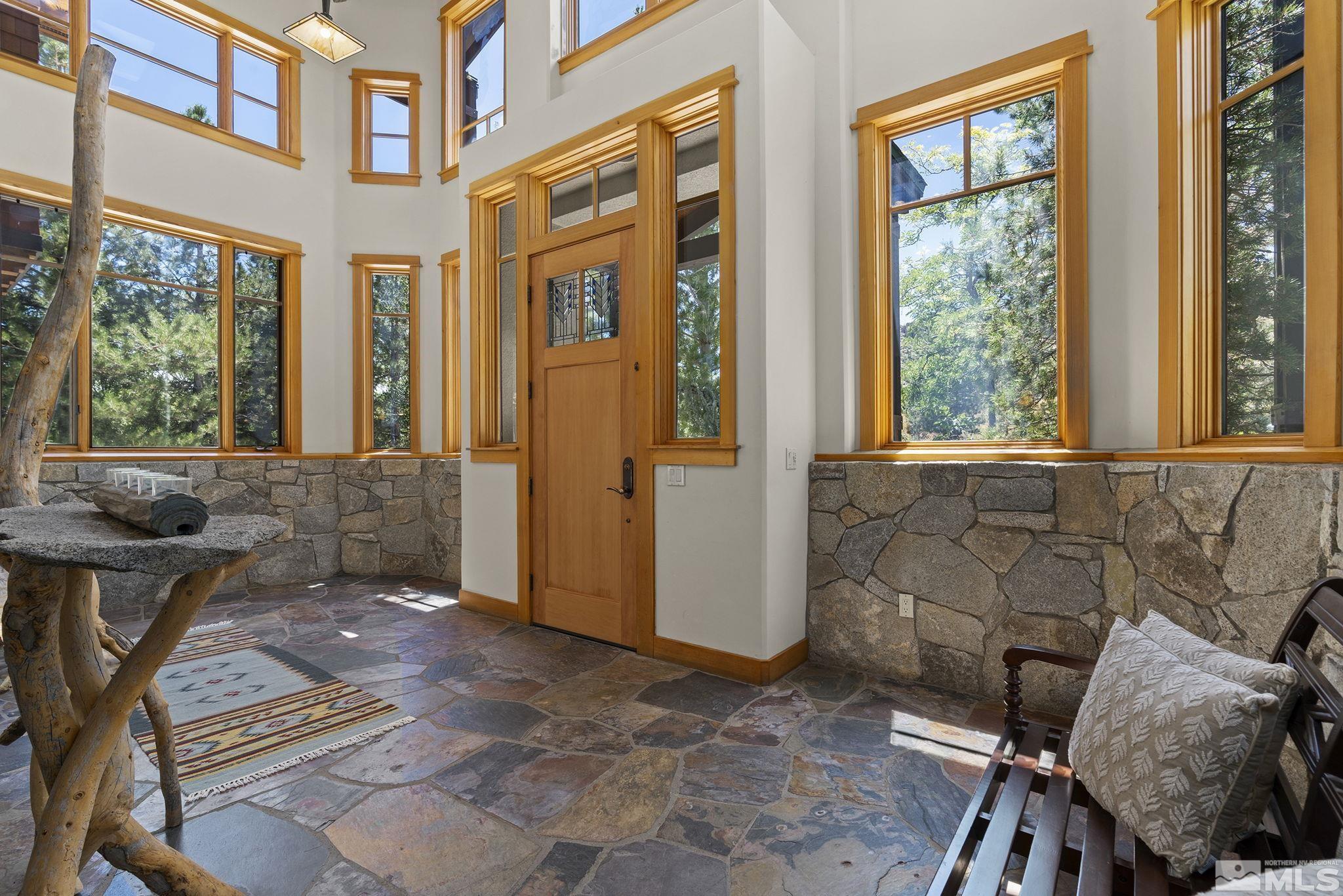 7035 Quail Rock Lane Reno, NV 89511 - Photo 5 of 37 a view of a brick house with outdoor seating