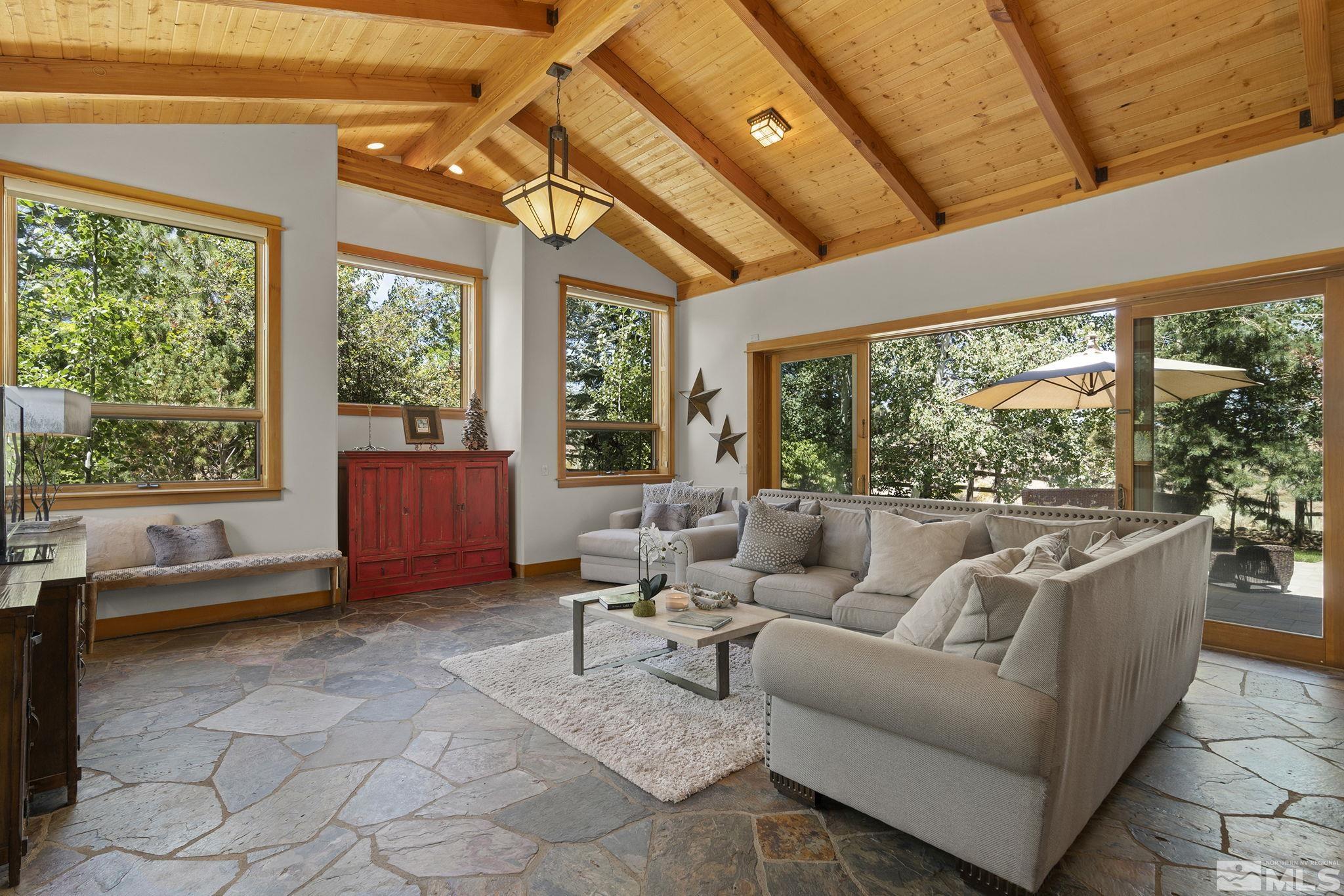 7035 Quail Rock Lane Reno, NV 89511 - Photo 7 of 37 a living room with furniture and a large window