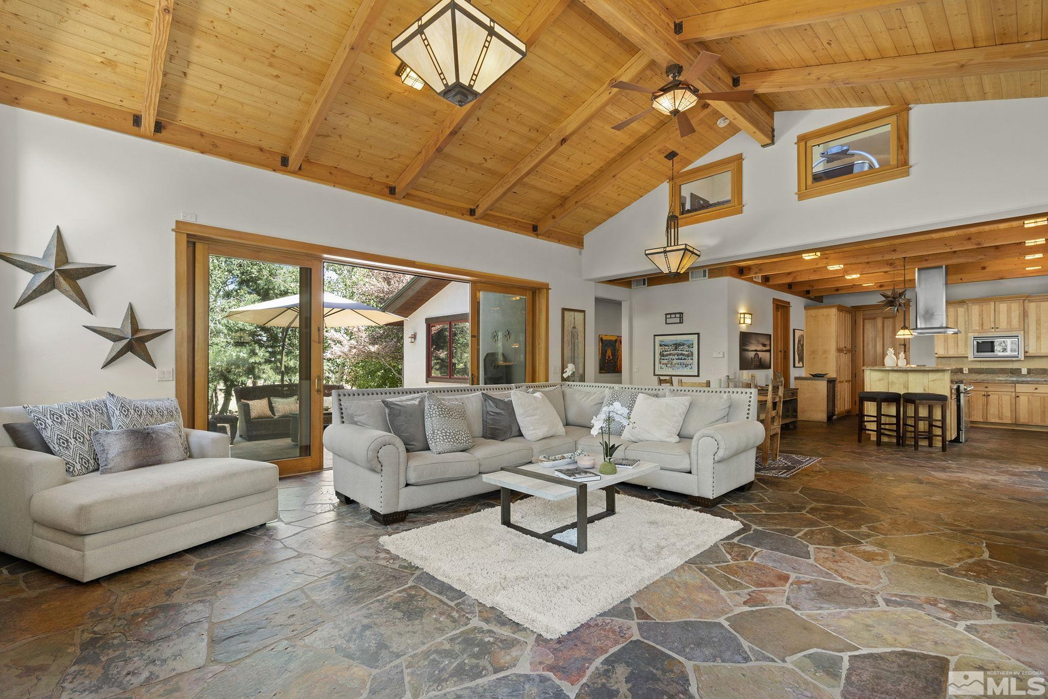 7035 Quail Rock Lane Reno, NV 89511 - Photo 9 of 37 a living room with furniture and a large window