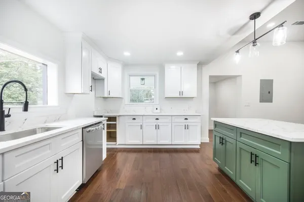 a kitchen with a sink cabinets and window