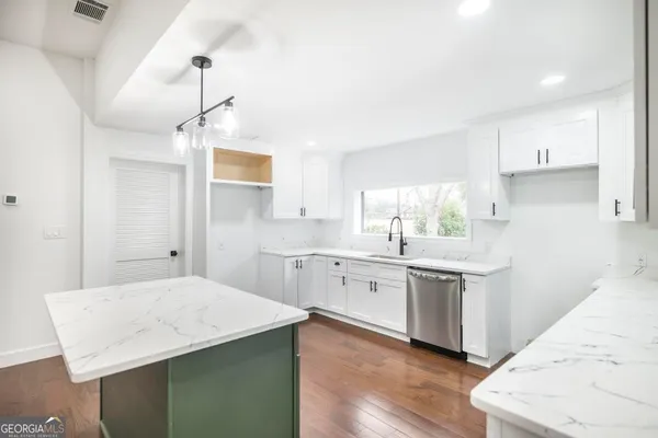 a kitchen with a sink and a large window