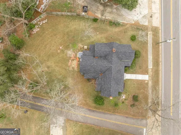an empty room with wooden floor and hallway