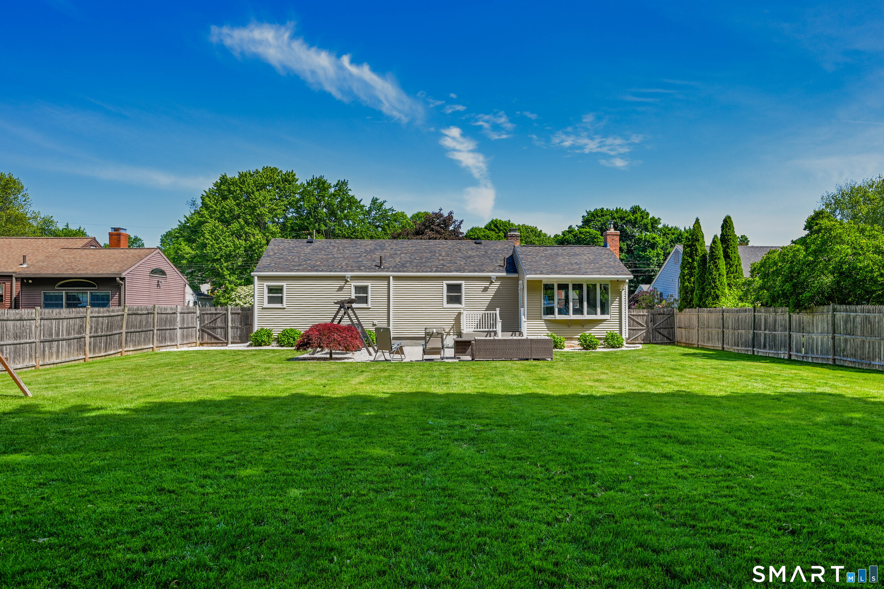 87 Lydall Road Newington, CT 06111 - Photo 28 of 35 a view of a house with a big yard potted plants and a large tree