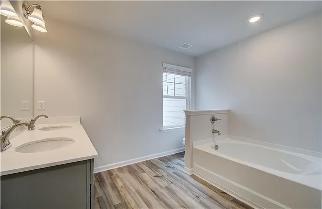 a white bath tub sitting next to a window