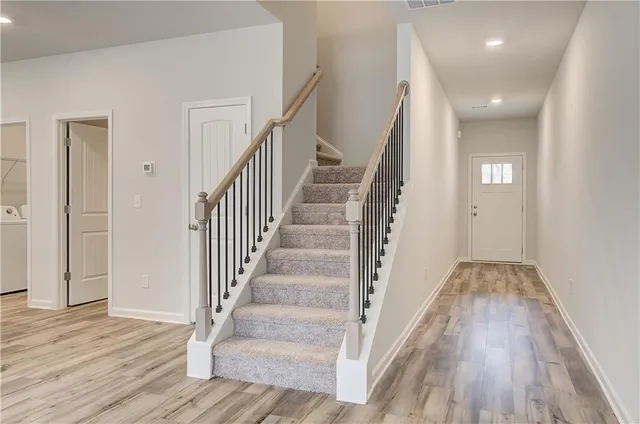 a view of staircase with wooden floor and staircase