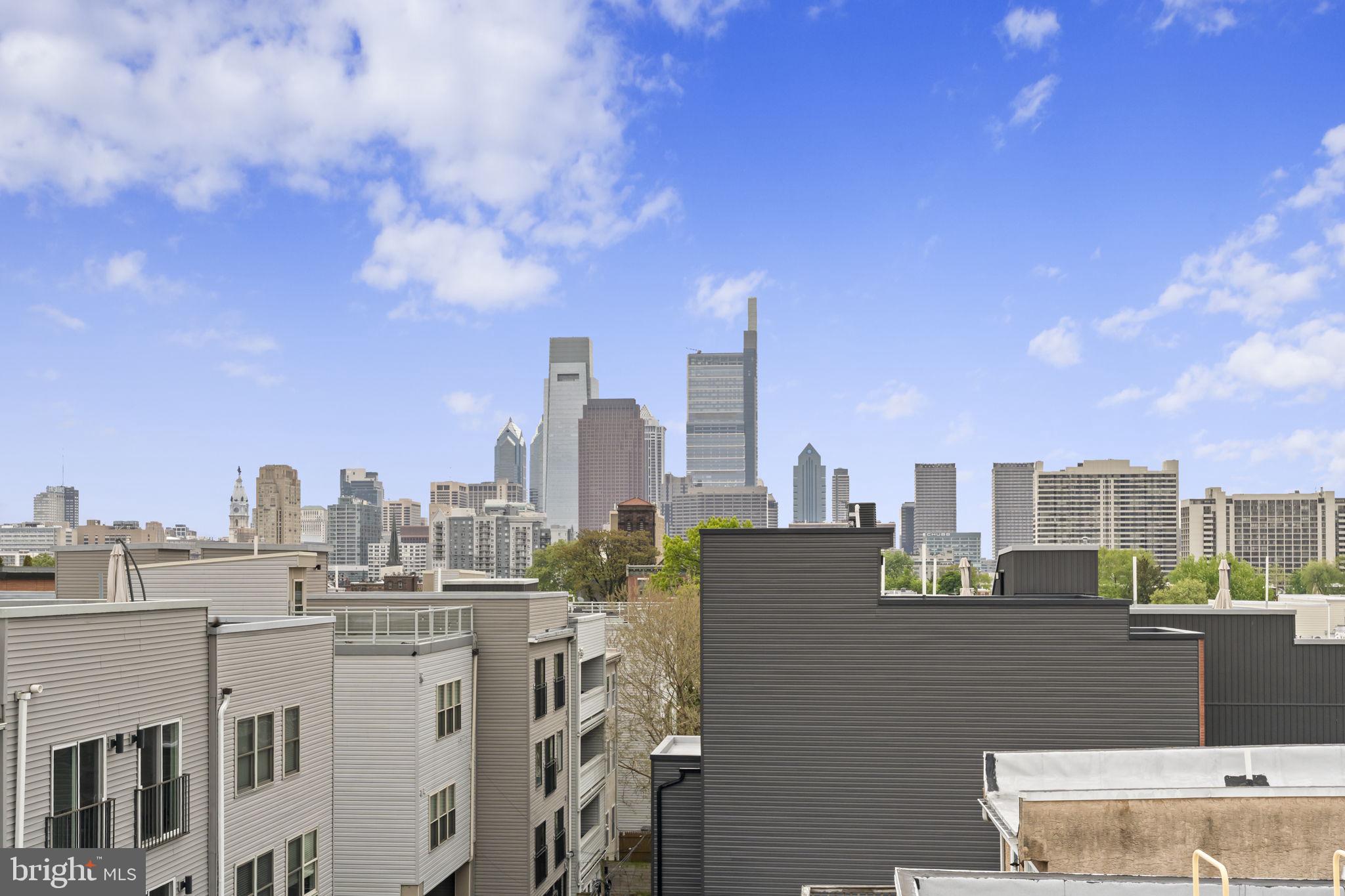 751 North Uber Street, Unit 3 Philadelphia, PA 19130 - Photo 33 of 36 Urban skyline with vibrant blue sky.