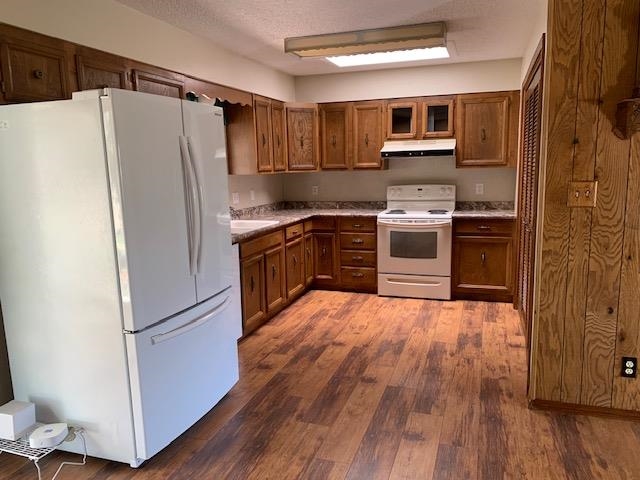 570 Southwest 2nd Court Cedaredge, CO 81413 - Photo 5 of 32 a kitchen with wooden floors and stainless steel appliances