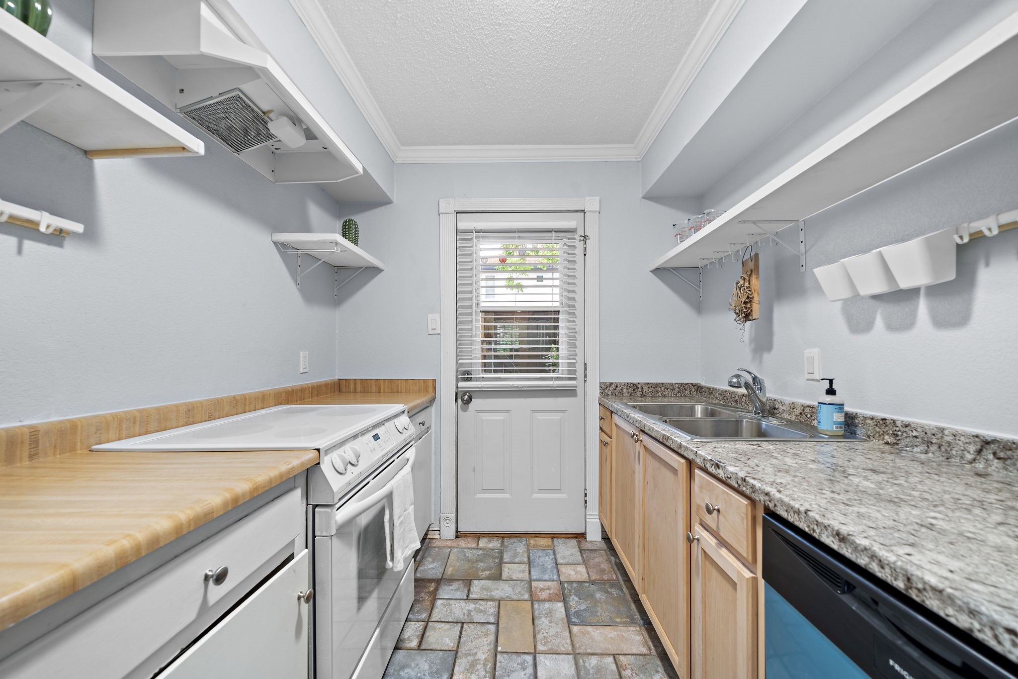 8289 Kingsbrook Road, Unit 173 Houston, TX 77024 - Photo 8 of 20 The kitchen opens up to an outdoor patio, perfect for dining or simply enjoying the fresh air.