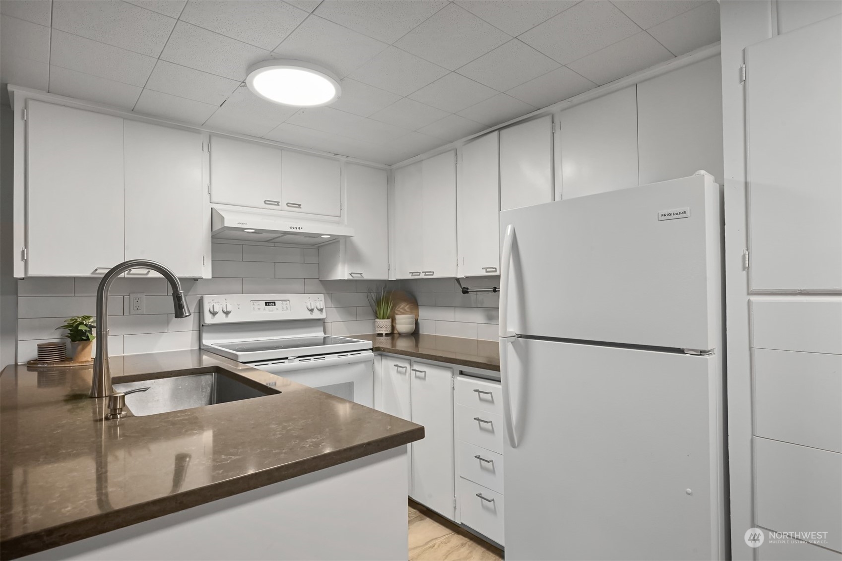 2907 Lynn Street Bellingham, WA 98225 - Photo 23 of 40 a kitchen with white cabinets and white appliances