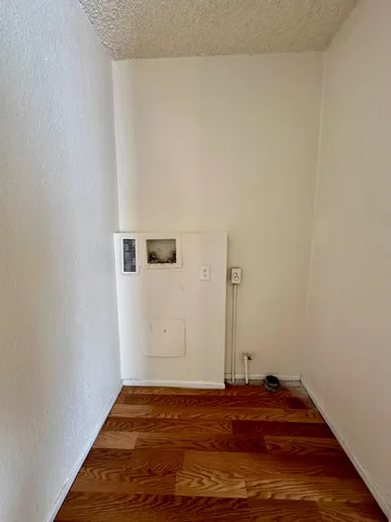 a view of a room with wooden floor
