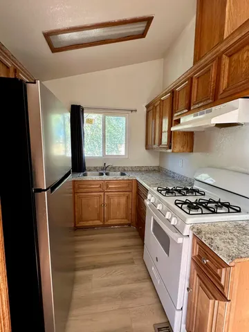 a kitchen with a stove a sink and a refrigerator