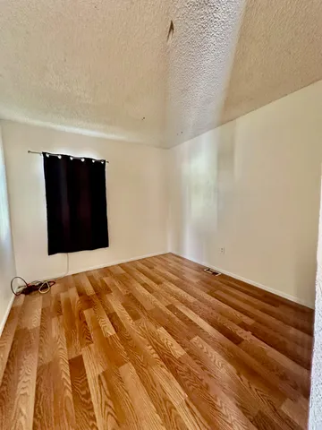 a view of a room with a wooden floor