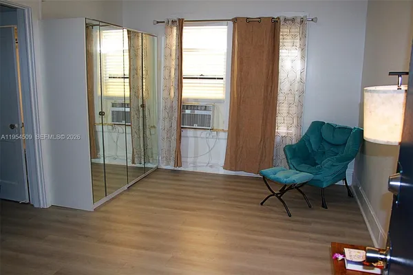 a view of a livingroom with furniture and a window
