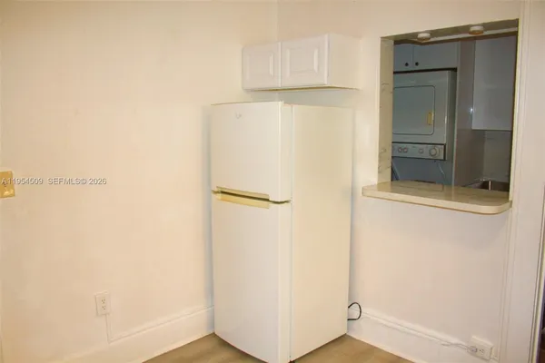 a white toilet sitting next to a shower