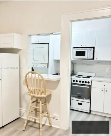 a kitchen with a stove a sink and a refrigerator