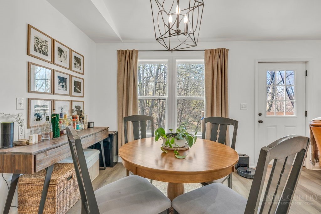 656 Mulatto Mountain Road West Jefferson, NC 28694 - Photo 21 of 35 a view of a dining room with furniture window and wooden floor