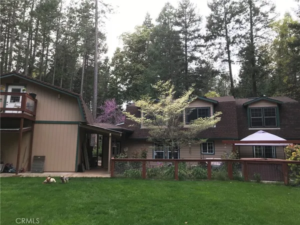 a bedroom with a large bed a chandelier and dresser