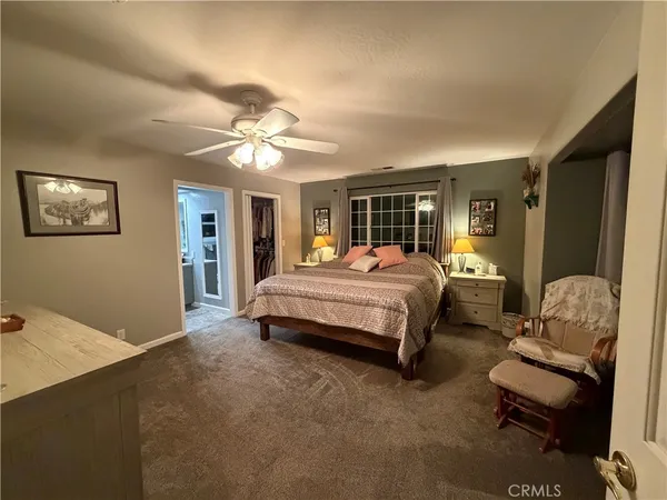 a bedroom with a bed couch and a window