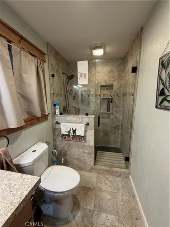 a view of a house with a yard and large trees