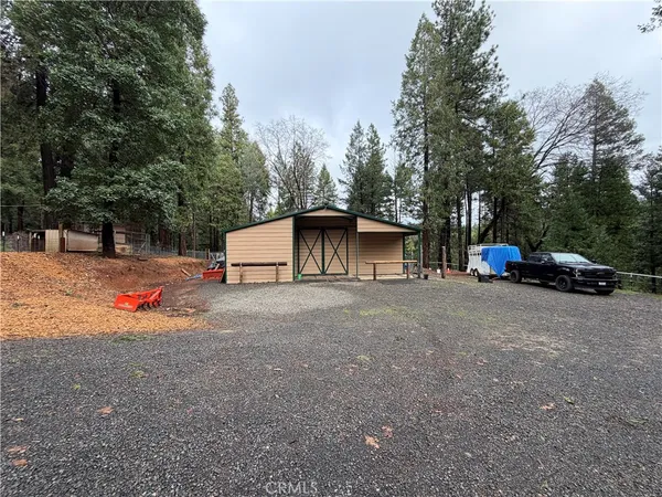 a view of a house with a tree in the background