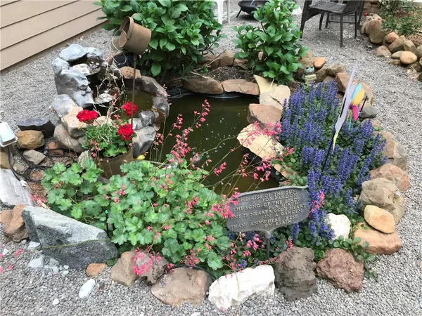 a view of a house with a yard and large trees