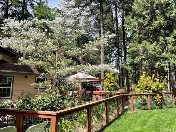 a view of a park with swings and a barbeque