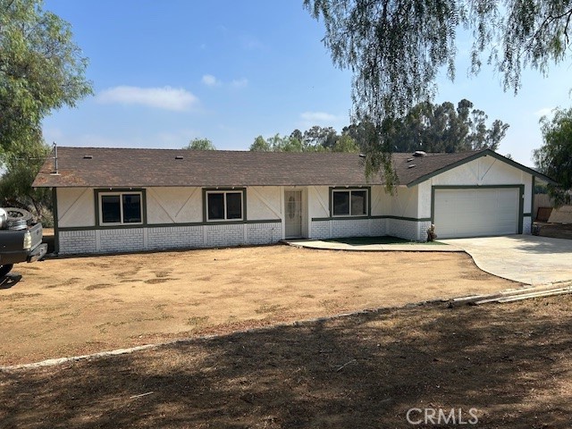 17260 Pfeifer Way Perris, CA 92570 - Photo 1 of 34 a front view of a house with a yard