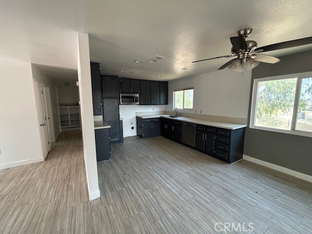17260 Pfeifer Way Perris, CA 92570 - Photo 8 of 34 a large kitchen with wooden floors and stainless steel appliances