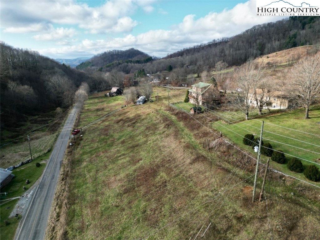 337-339 Greer Lane Vilas, NC 28692 - Photo 3 of 11 a view of a wooden house with a yard