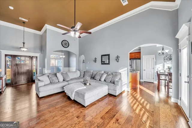 a living room with furniture and kitchen view