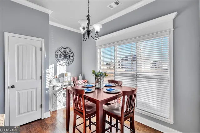 a view of a dining room with furniture window and wooden floor