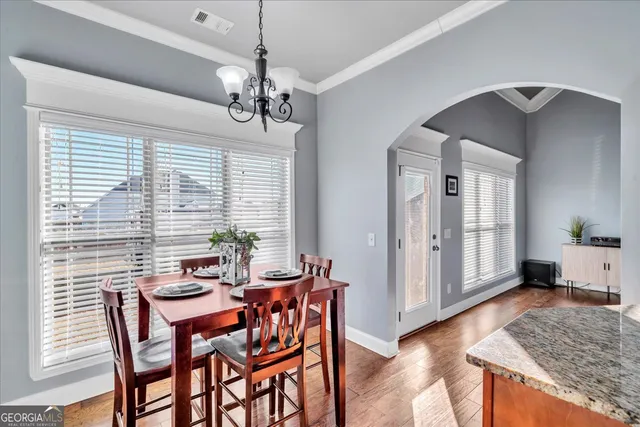 a view of a dining room with furniture window and wooden floor
