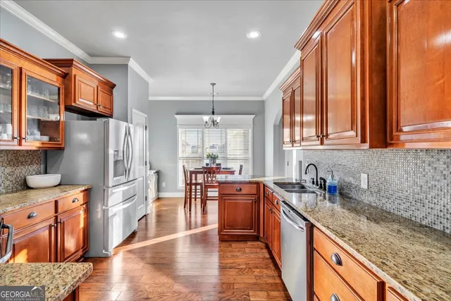 a kitchen with stainless steel appliances granite countertop a sink stove and refrigerator