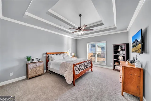 a bed room with a bed and a flat tv screen