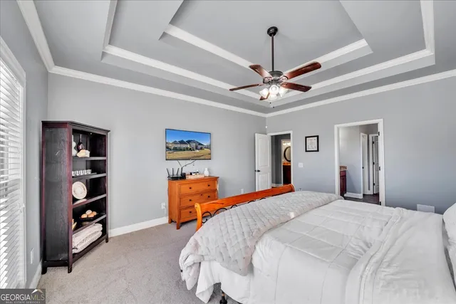a bedroom with bed and a chandelier