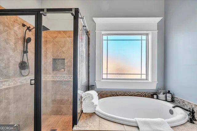 a white bath tub sitting next to a shower