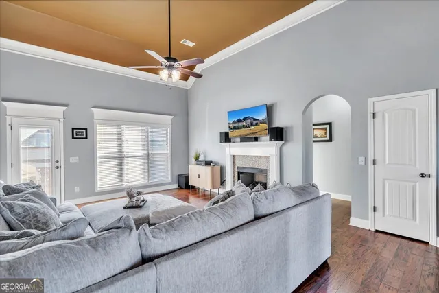 a living room with furniture a fireplace and a chandelier