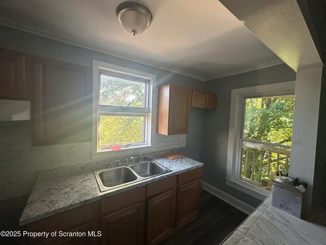 a kitchen with a sink and large window